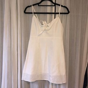 White linen dress with tie embellishments